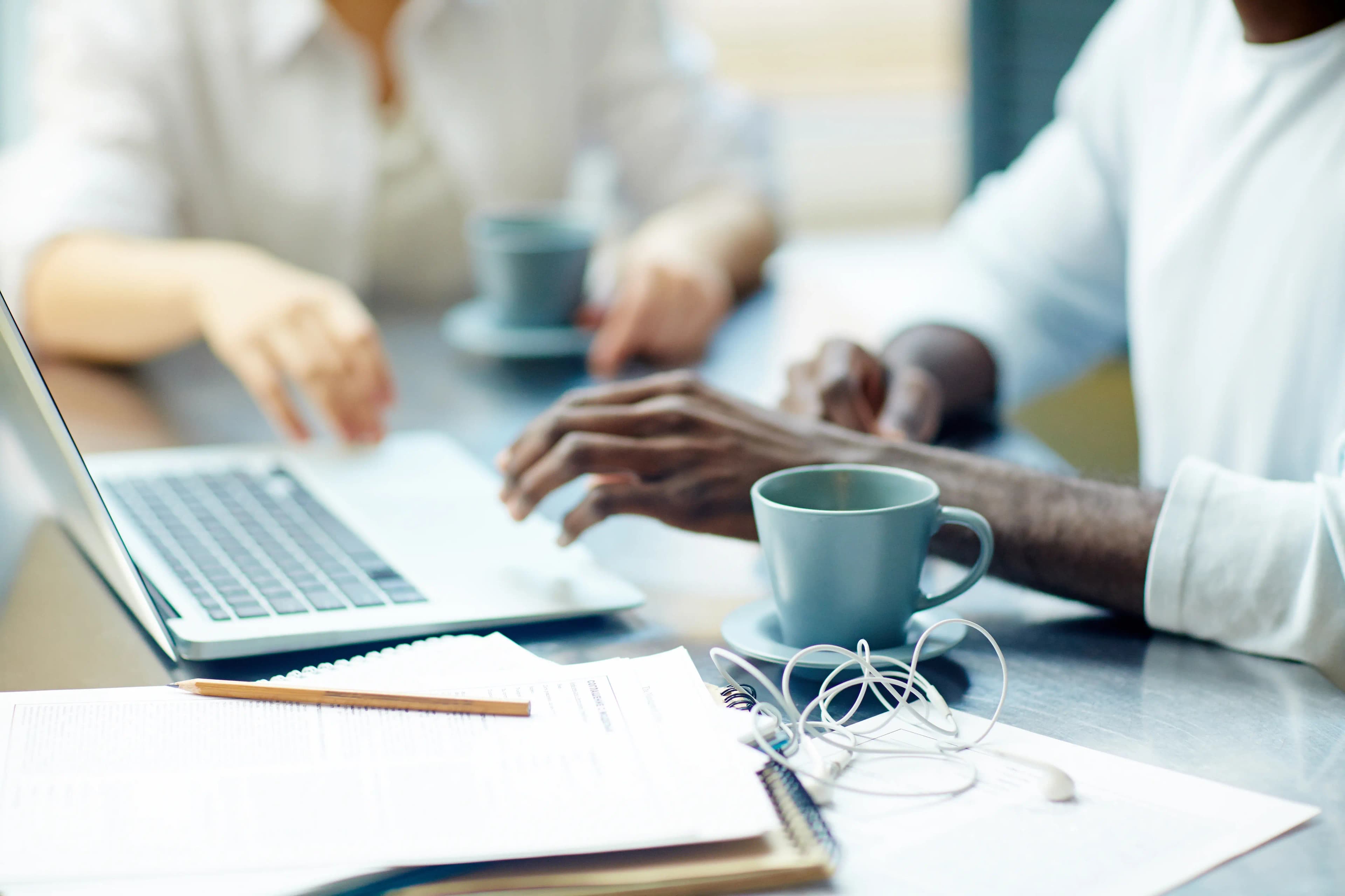 Business professionals collaborating at a laptop